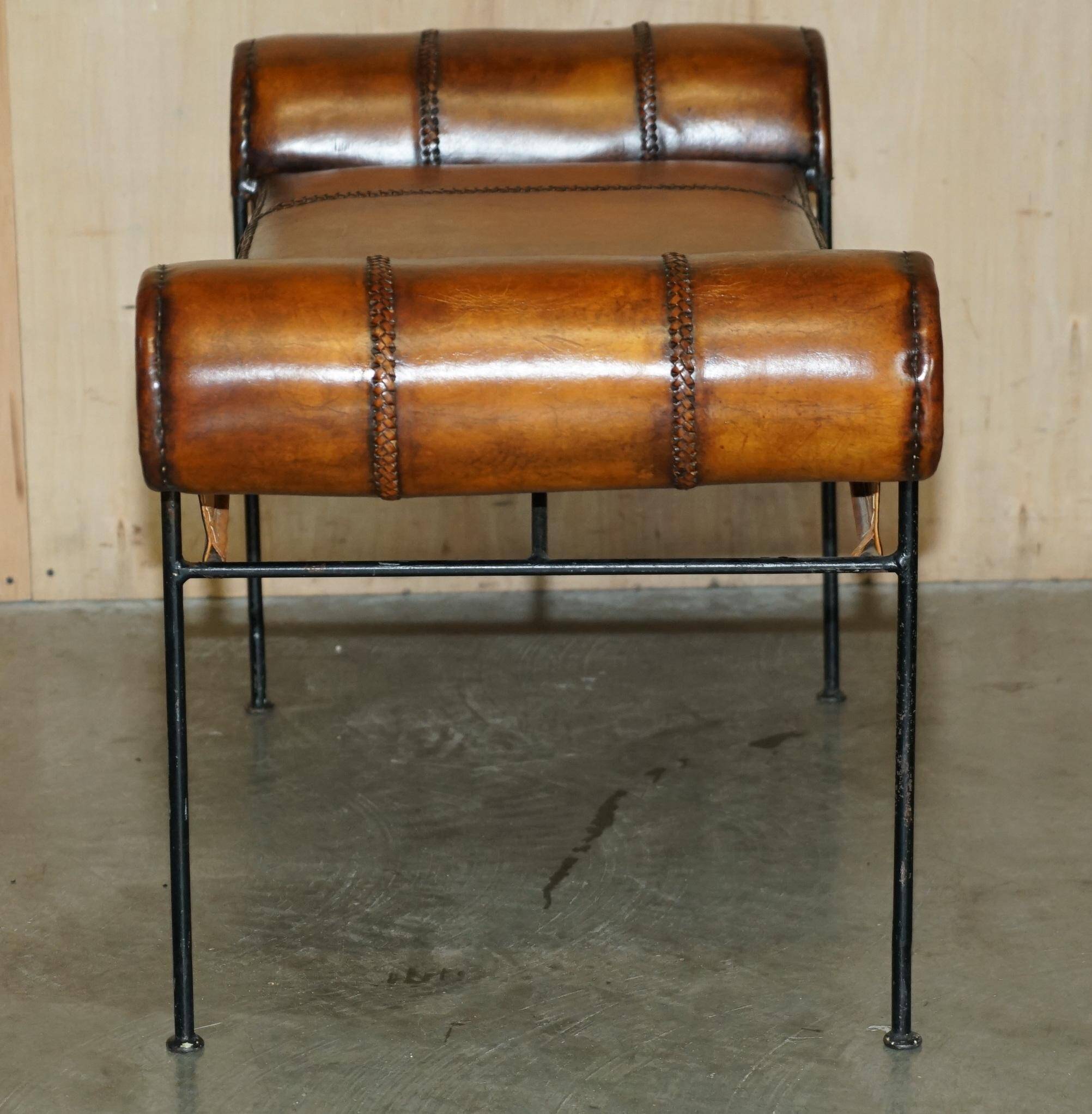 Vintage Spanish window bench in hand-stitched leather and restored iron.