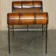 Vintage Spanish window bench in hand-stitched leather and restored iron.
