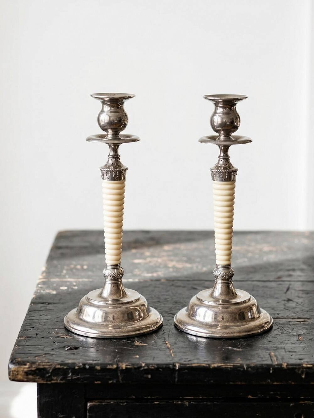 Pair of vintage candlestick holders in silver-plated metal with ivory-style plastic.