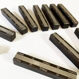 Set of 11 ebony wood knife rests with brass inlay