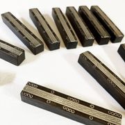 Set of 11 ebony wood knife rests with brass inlay