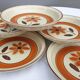 Set 11 plates 1970 Revernay Sarreguemines orange and brown on sandstone background