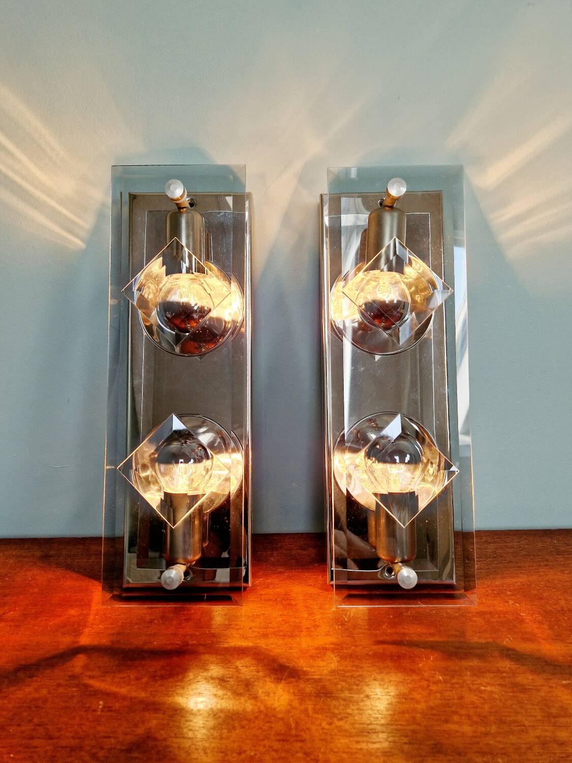 Pair of chrome metal and smoked glass wall sconces, 1970s.
