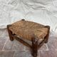 Rustic footrest made of wood and straw