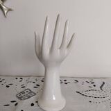 Hand holds white jewelry, ring sizer