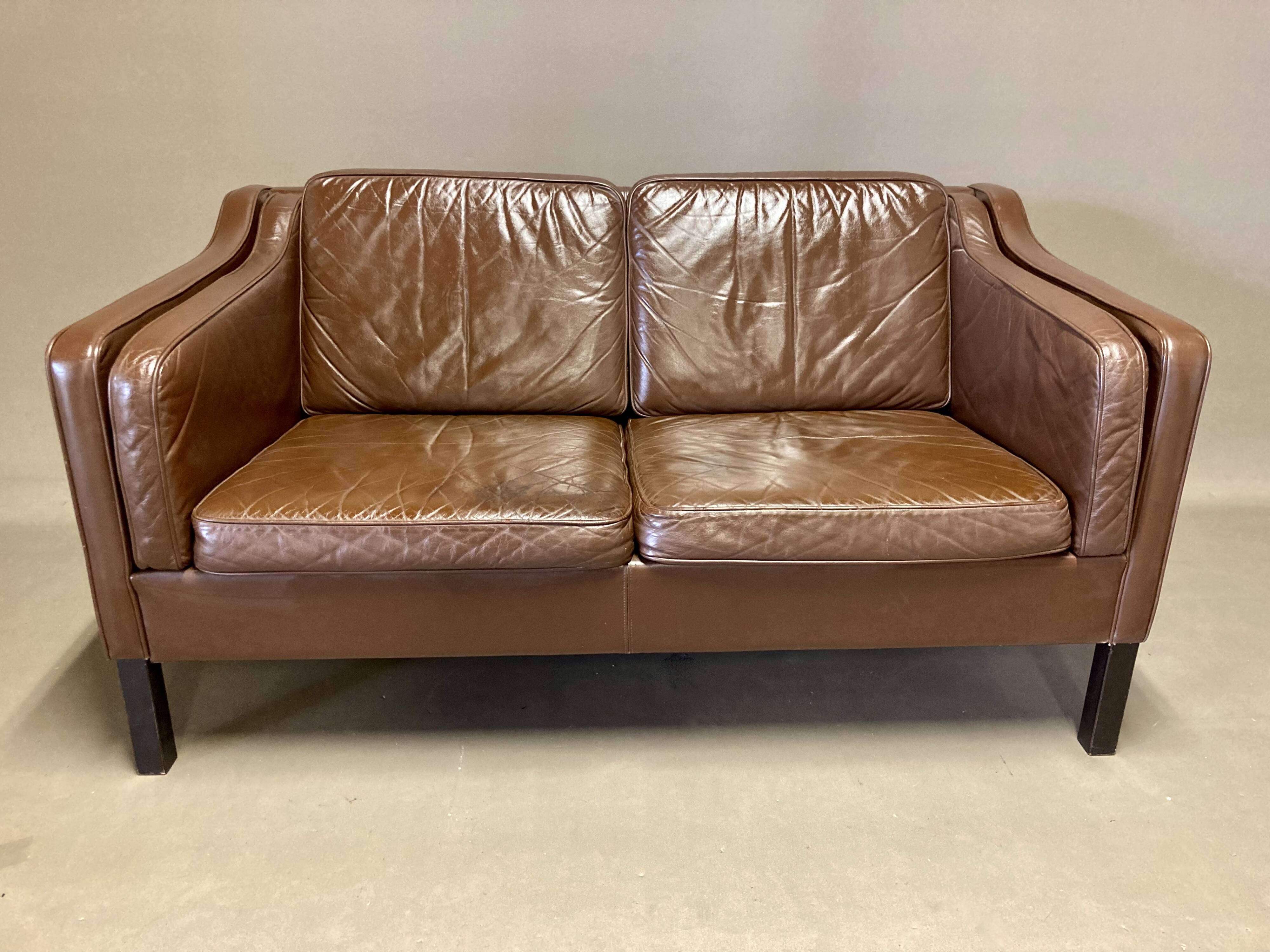 Scandinavian design 2-seater leather sofa.