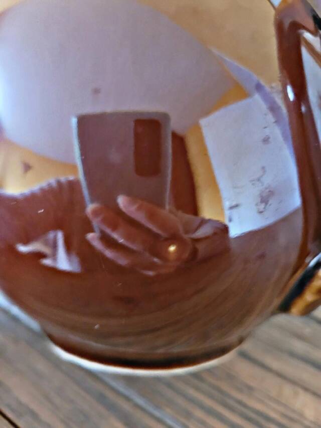 Vintage ceramic teapot (glazed earthenware) in brown colour.