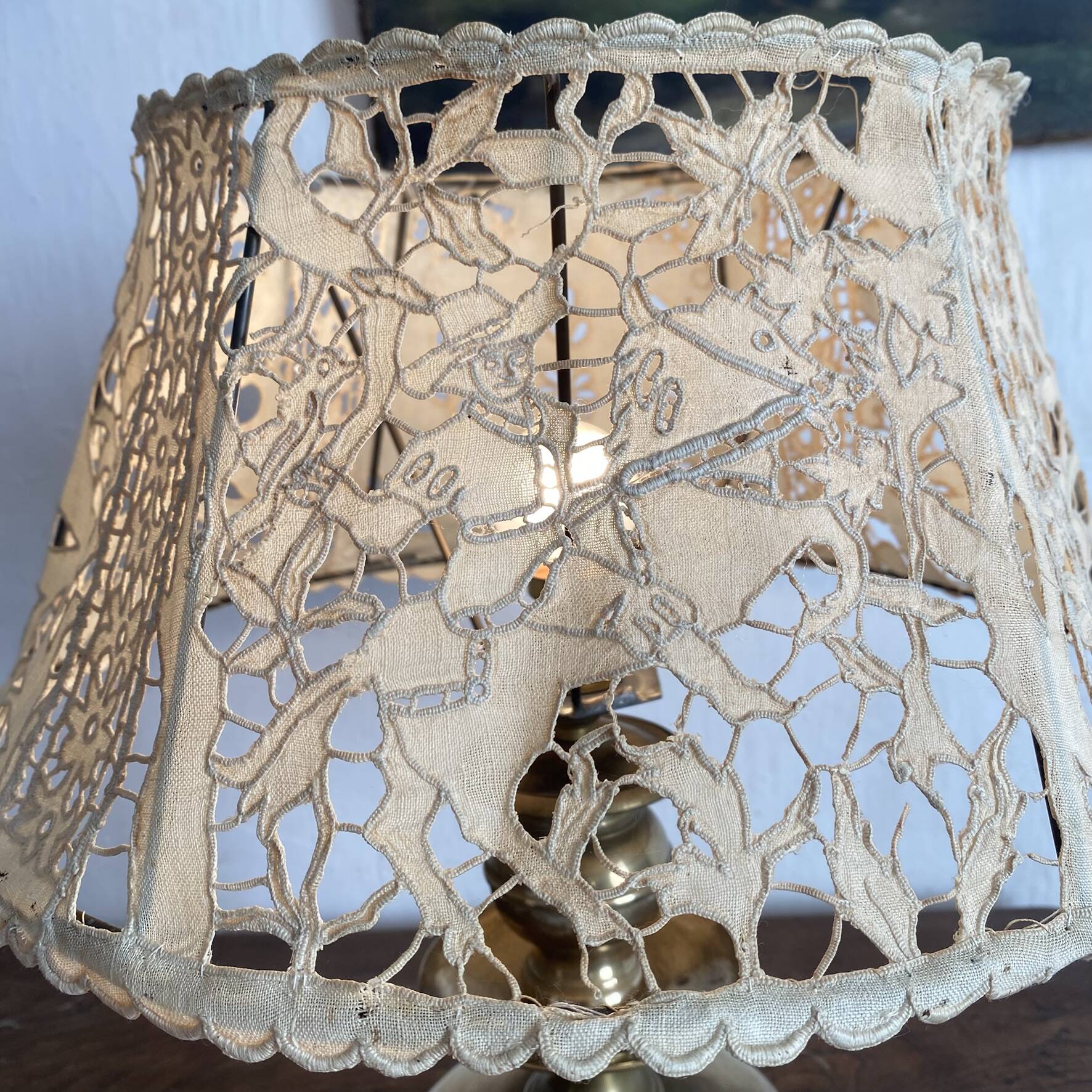 Antique brass lamp with embroidered openwork shade.