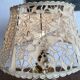 Antique brass lamp with embroidered openwork shade.