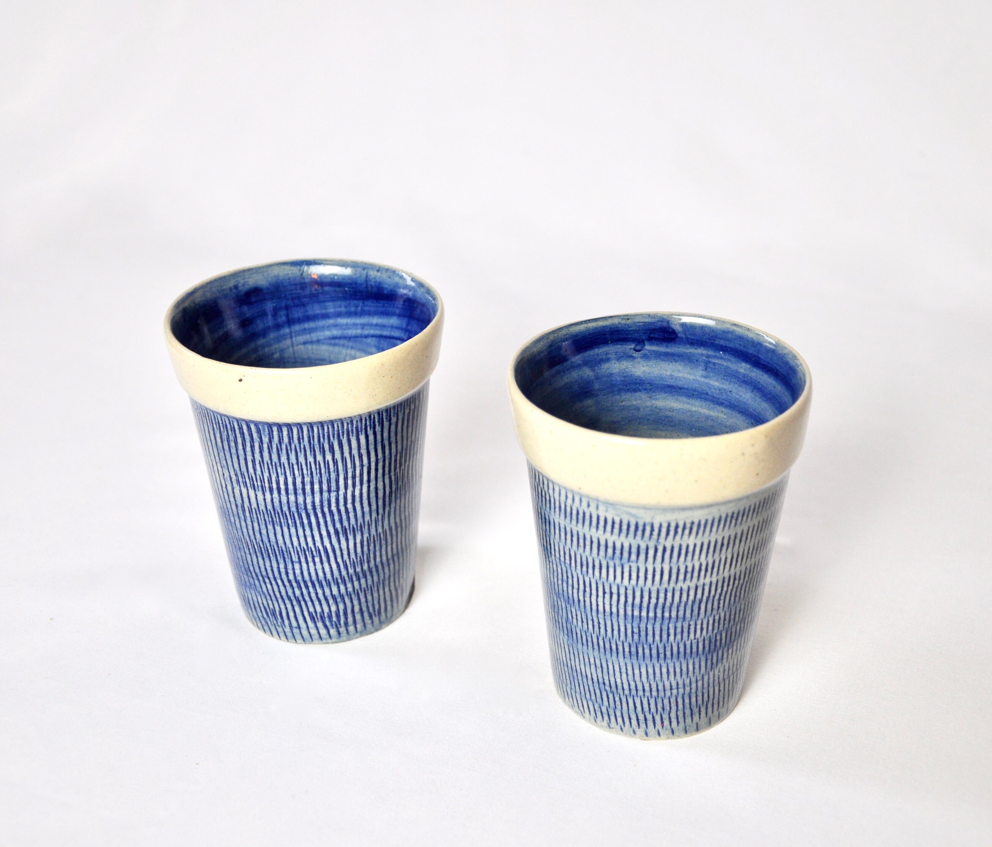 2 blue textured ceramic mugs