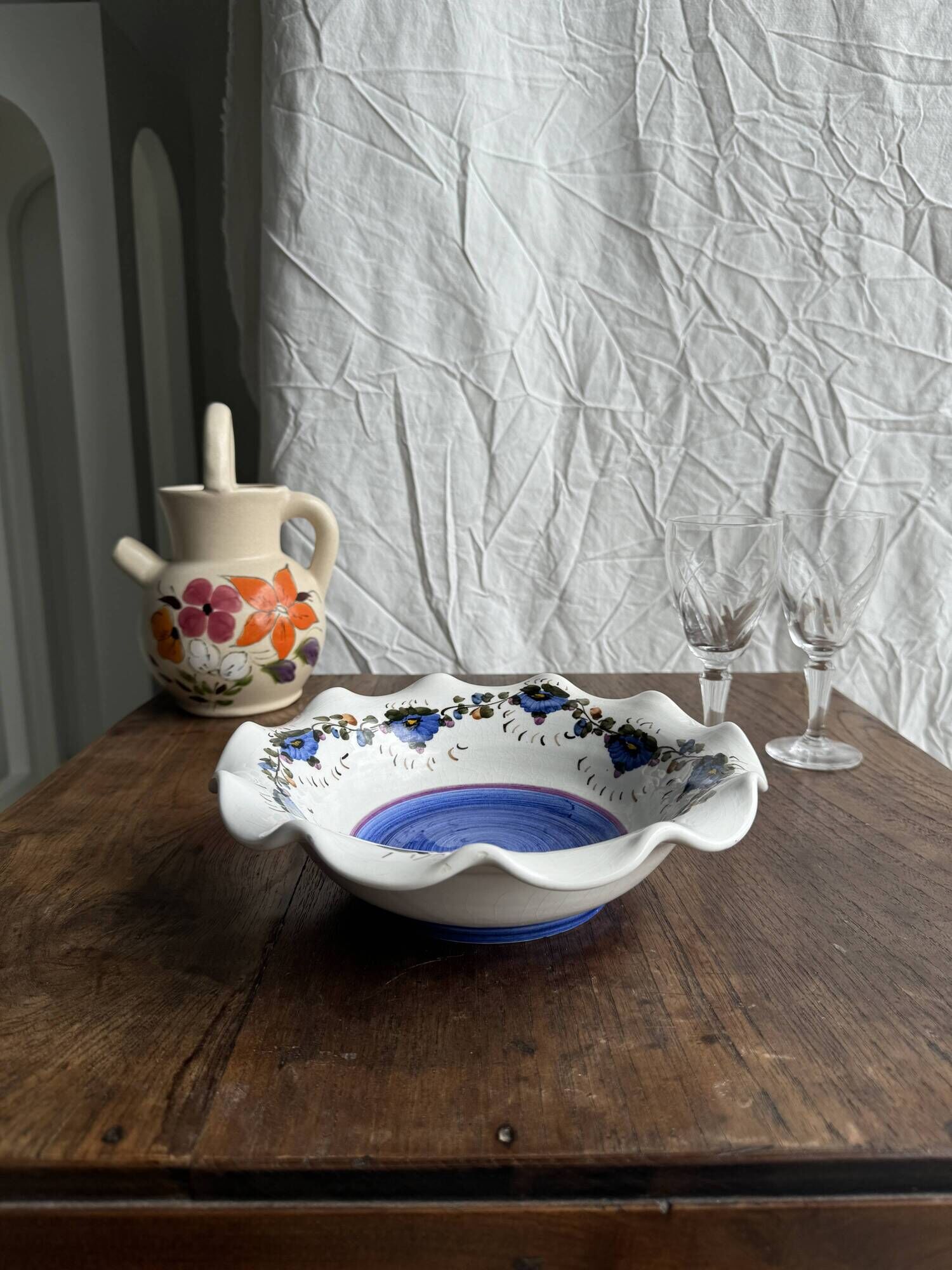 Small hand-painted earthenware salad bowl with garland of blue flowers, mark below