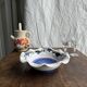 Small hand-painted earthenware salad bowl with garland of blue flowers, mark below