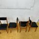 4 Scandinavian chairs in teak and black faux leather.