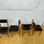 4 Scandinavian chairs in teak and black faux leather.