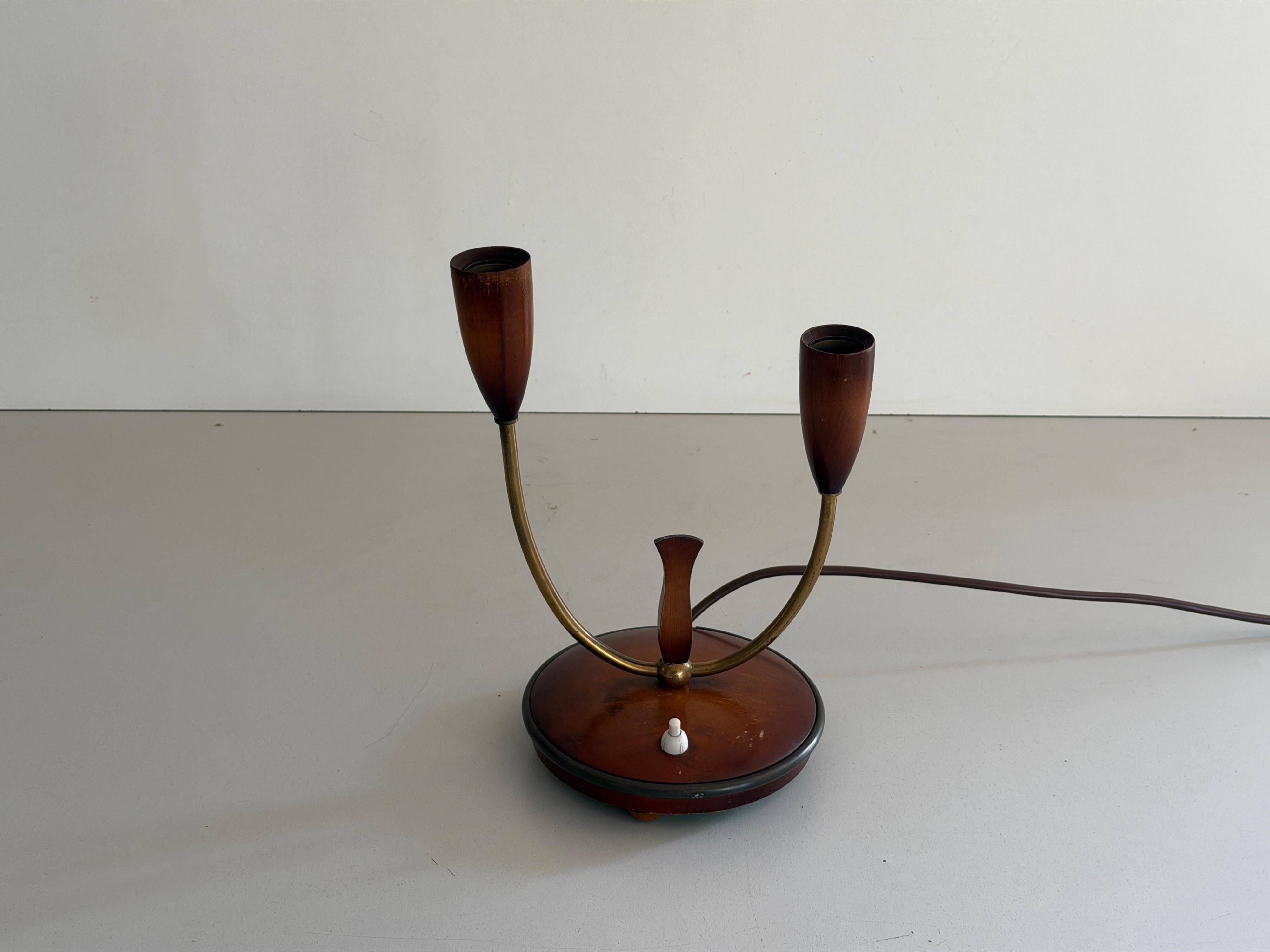 Simple double-headed table lamp in wood and brass, 1960s, Germany.