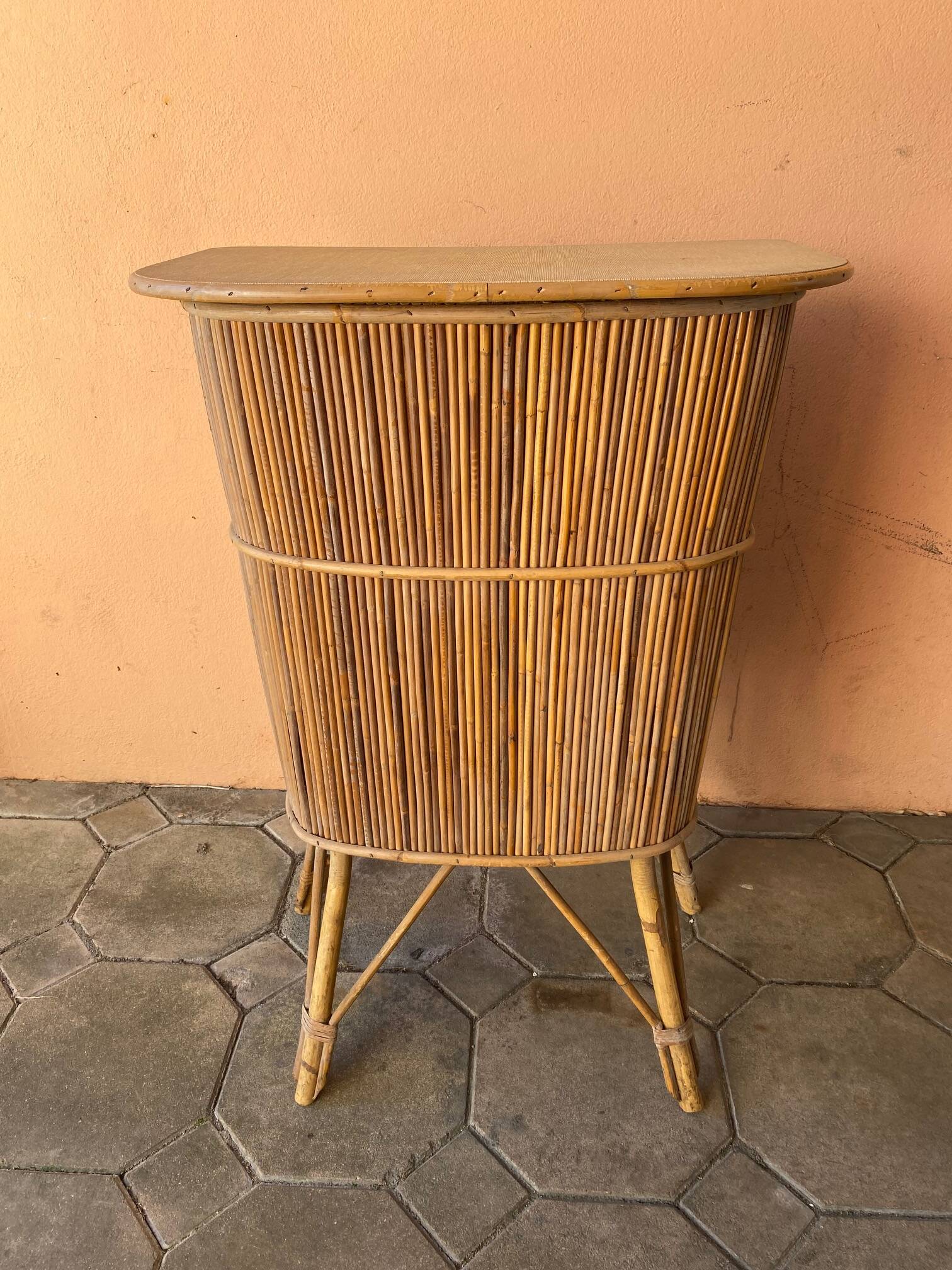 Vintage rattan bar from the 60s with rounded shapes and a shelf for glasses