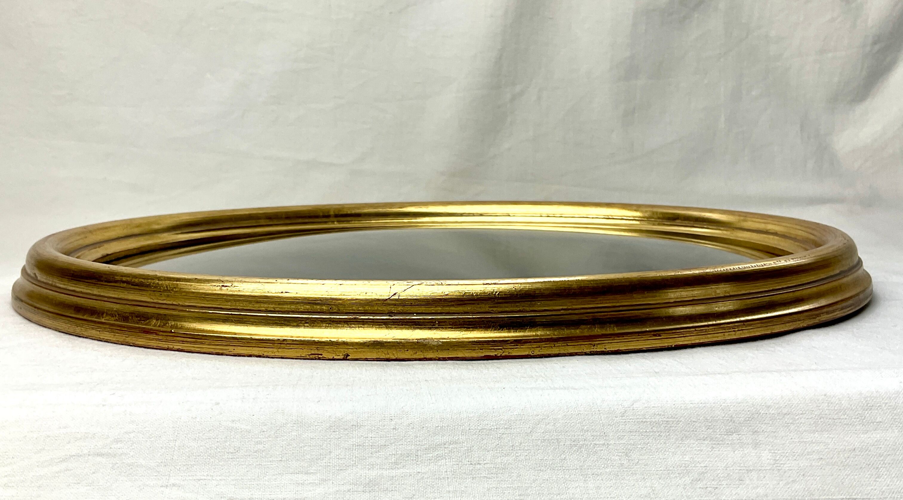 Old oval gilded wooden frame with domed glass