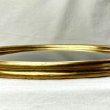 Old oval gilded wooden frame with domed glass