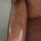 Cowhide wingback armchair in English style finished with decorative nails