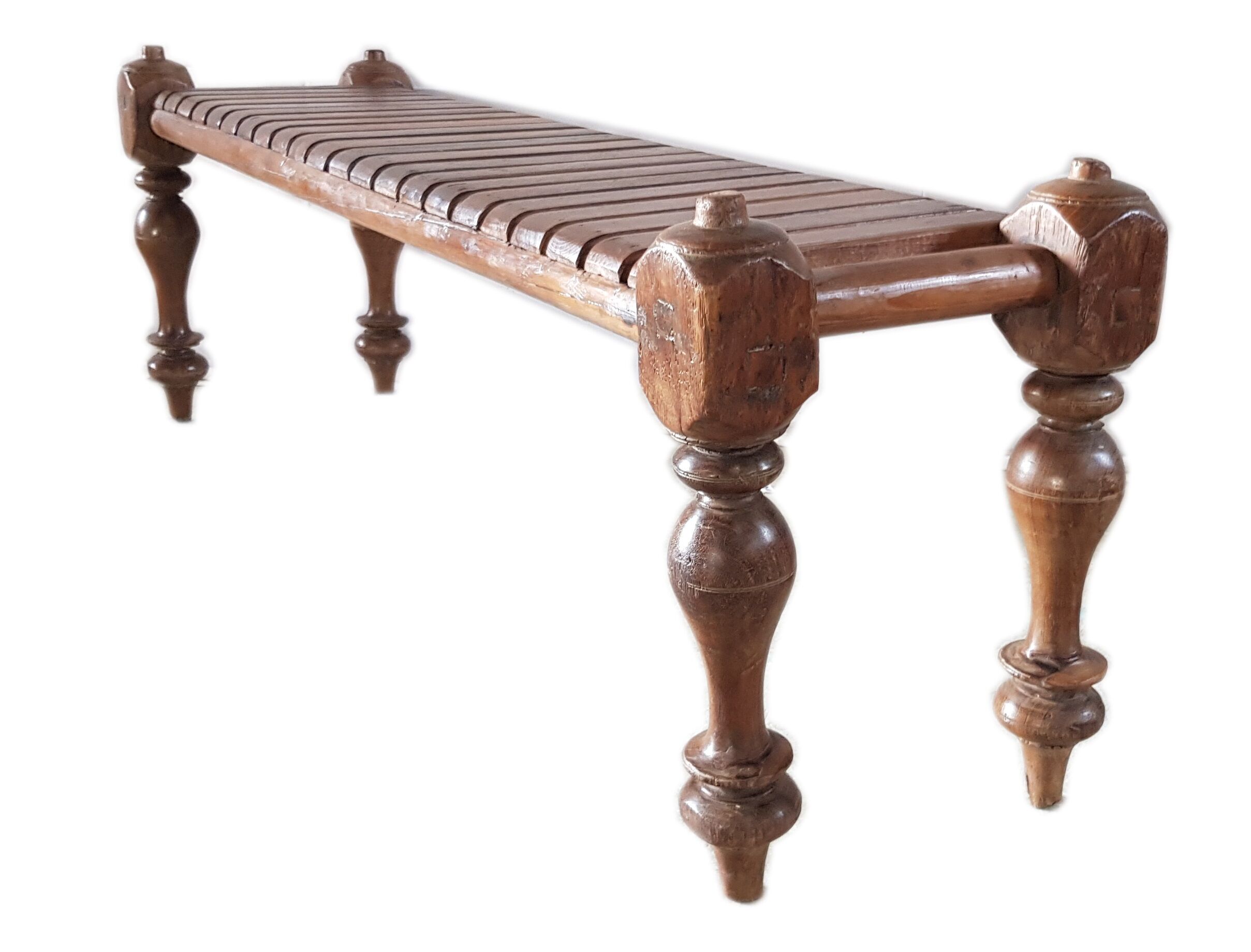 Bench with slats and feet of charpoy beds in teak