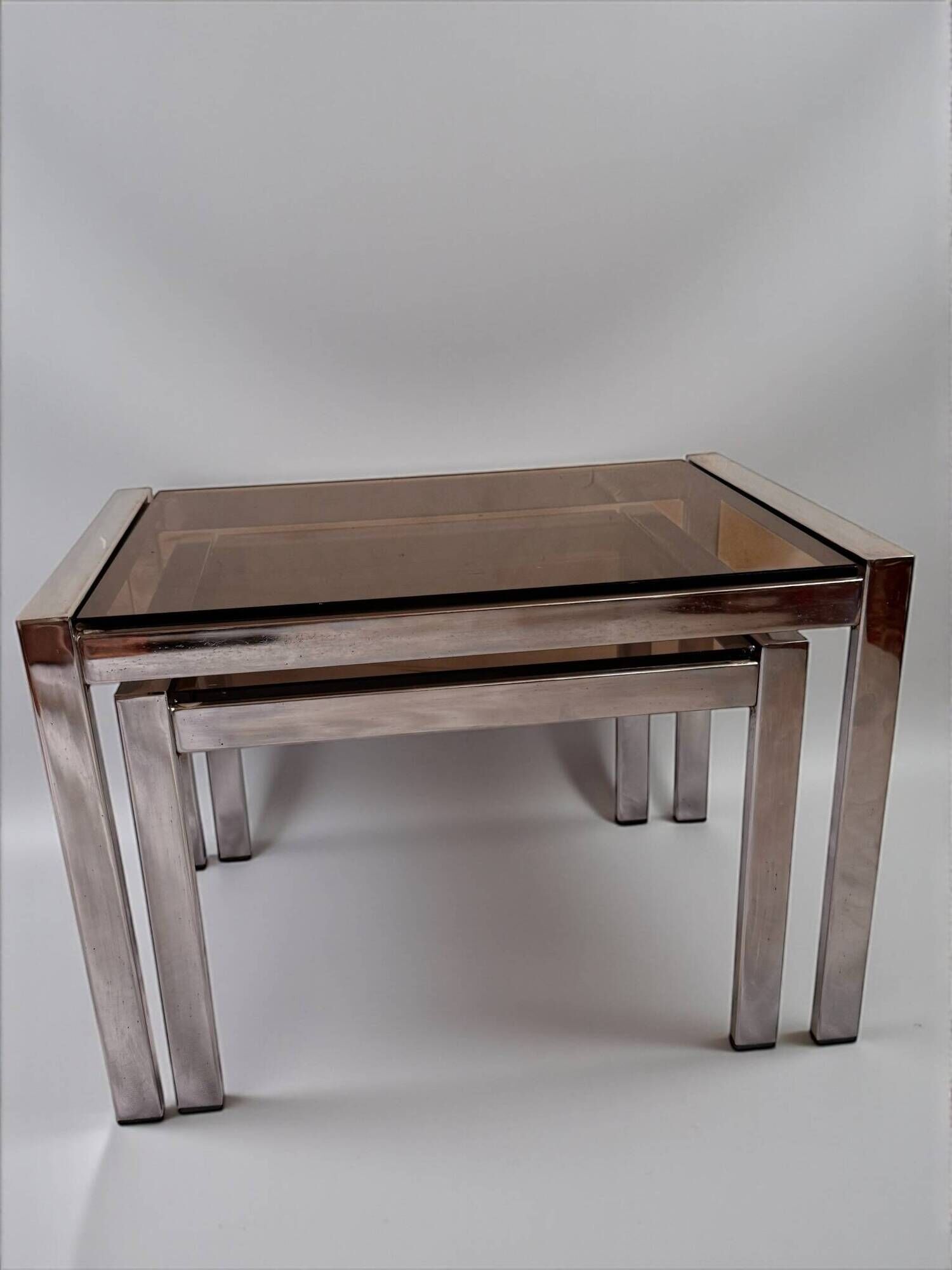 Vintage 1970s nesting tables in chrome and smoked glass, mid-century modernist style