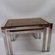 Vintage 1970s nesting tables in chrome and smoked glass, mid-century modernist style
