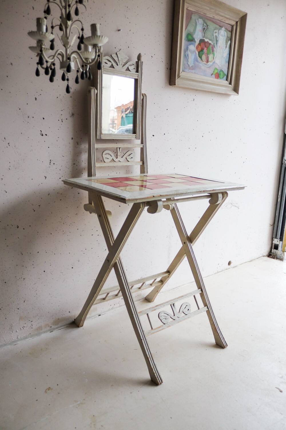 Small antique folding wooden dressing table with tiles and a mercury mirror.