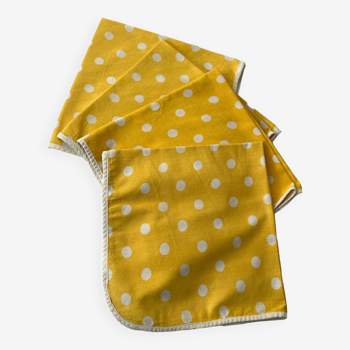 4 yellow napkins with white polka dots
