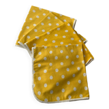 4 yellow napkins with white polka dots