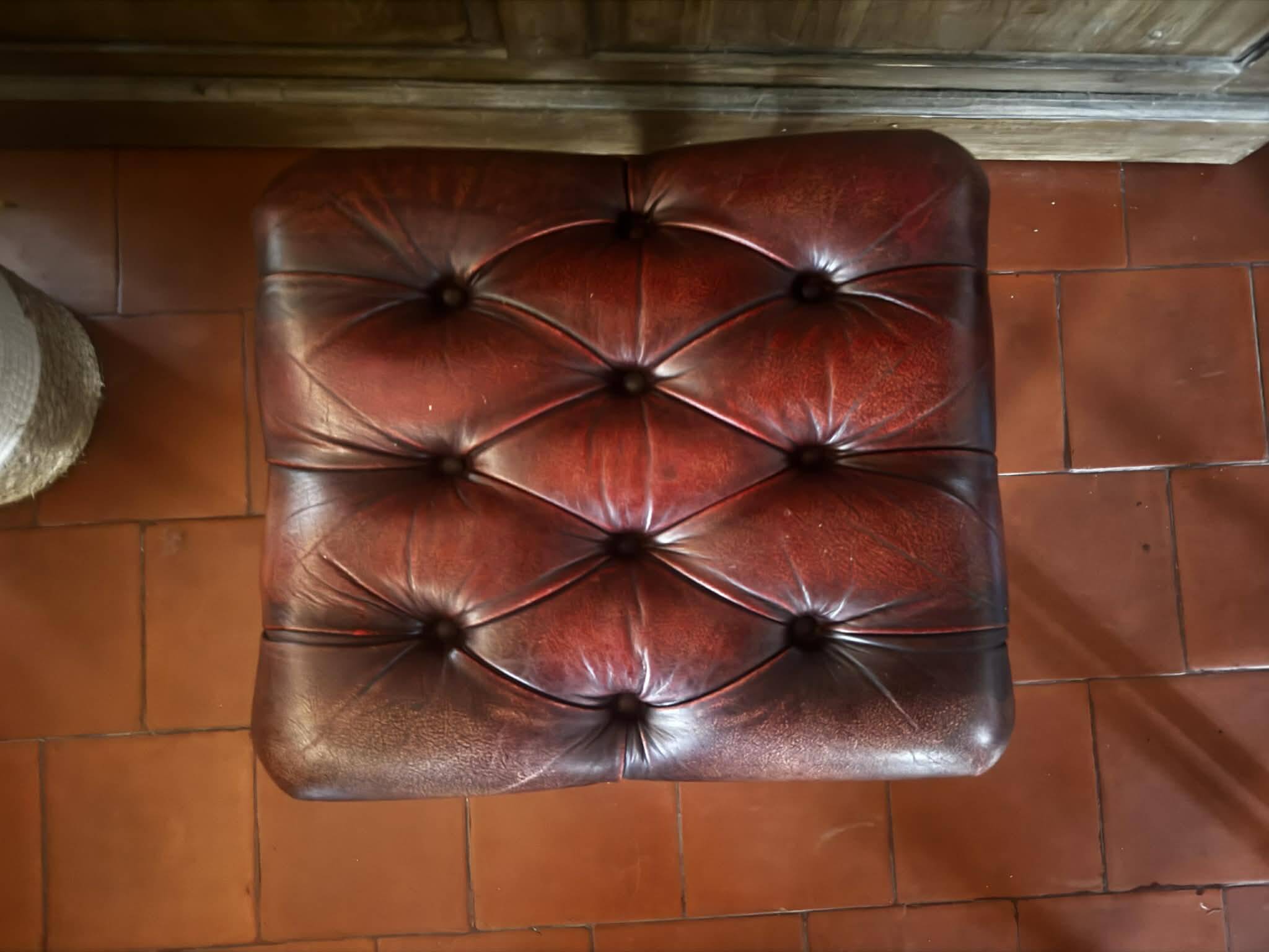 Red leather footrest in Chesterfield style, vintage 1970s.