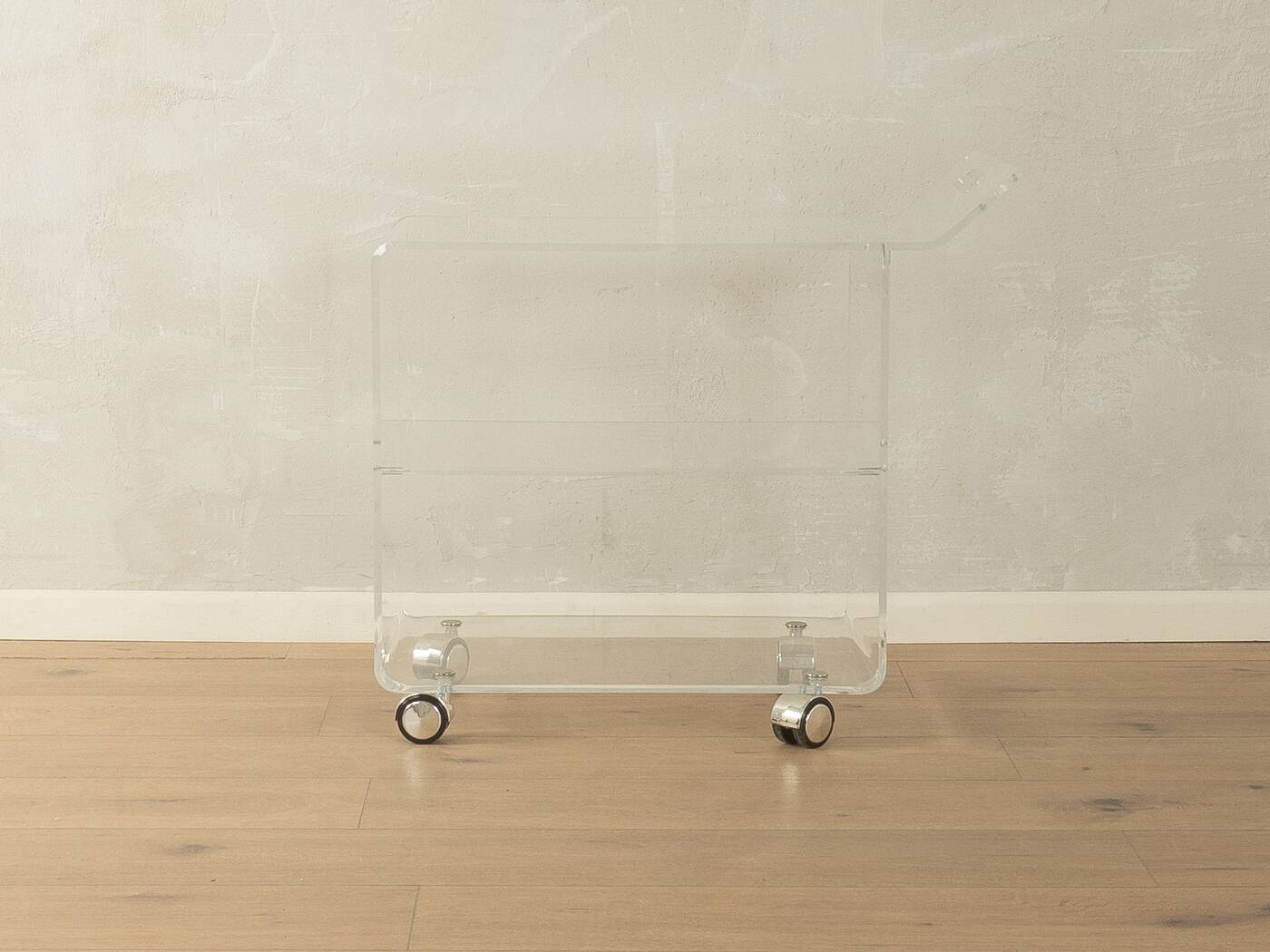 Wonderful side table from the 1960s, high-quality frame and shelf made of transparent acrylic with chrome-plated castors