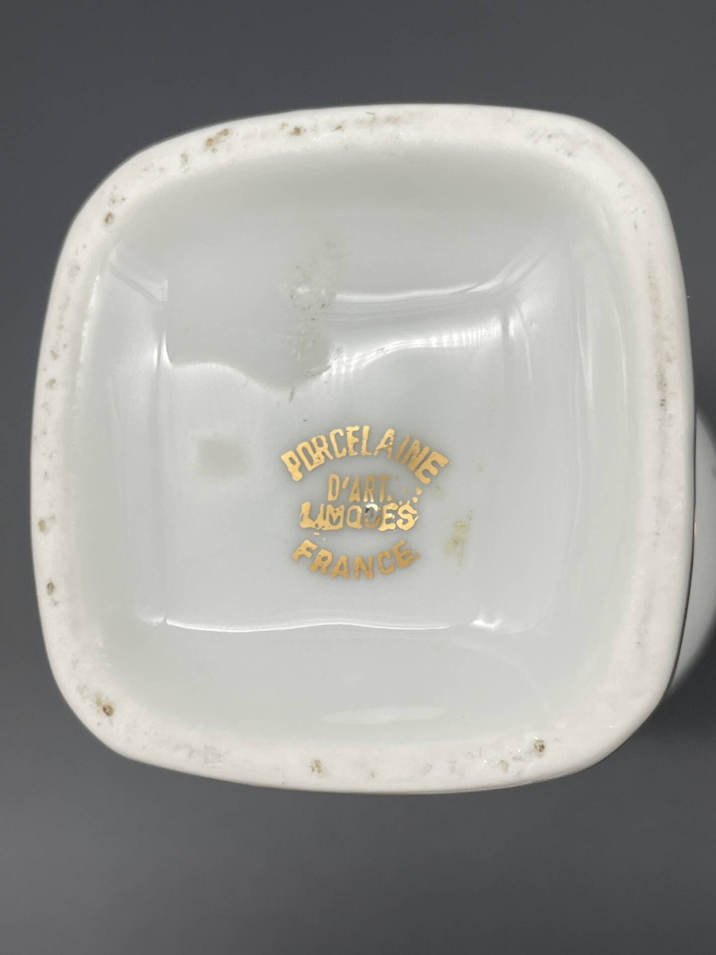 Small amphora vase in Limoges porcelain with gilded handles.