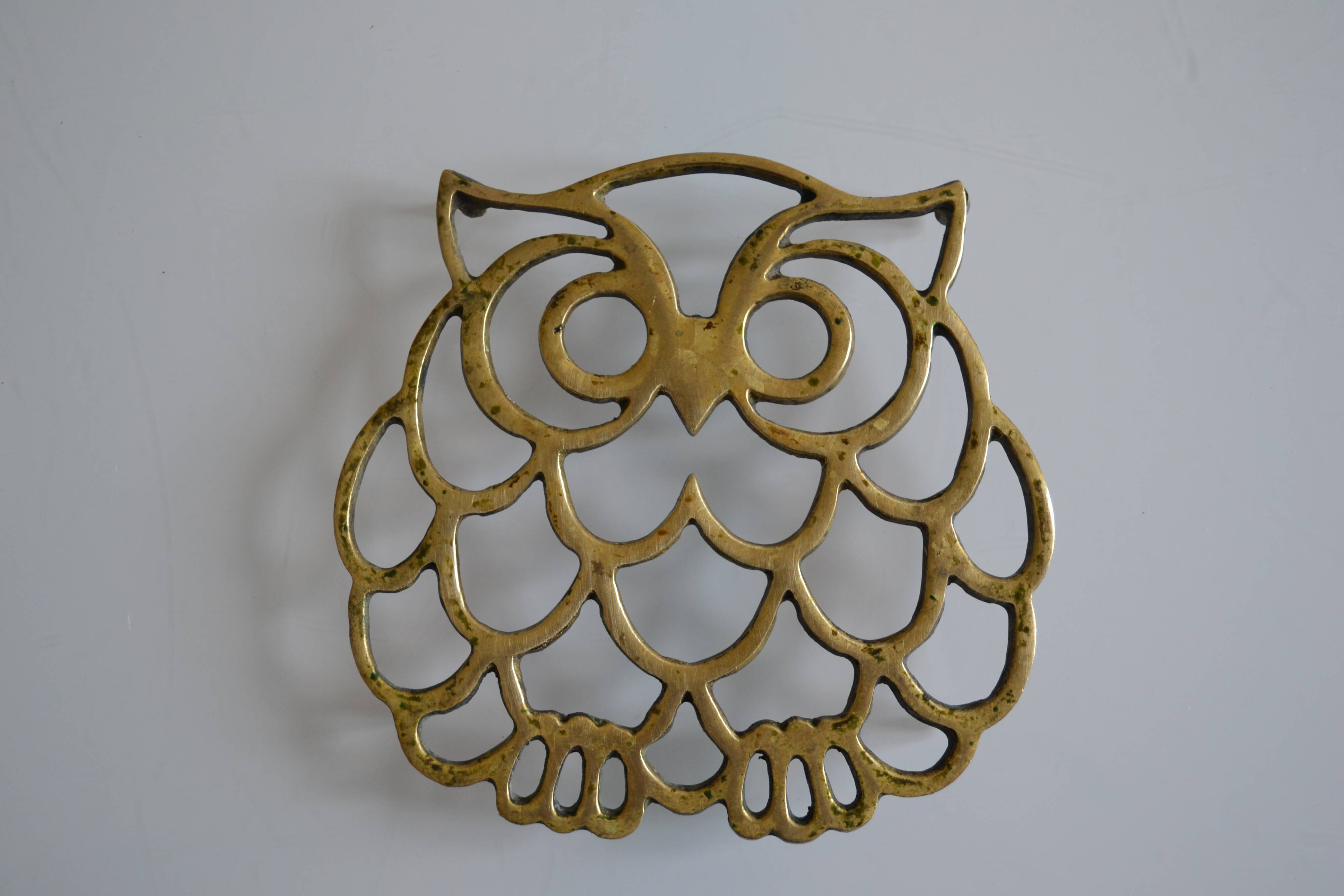 Vintage openwork brass trivet in the shape of an owl or owl