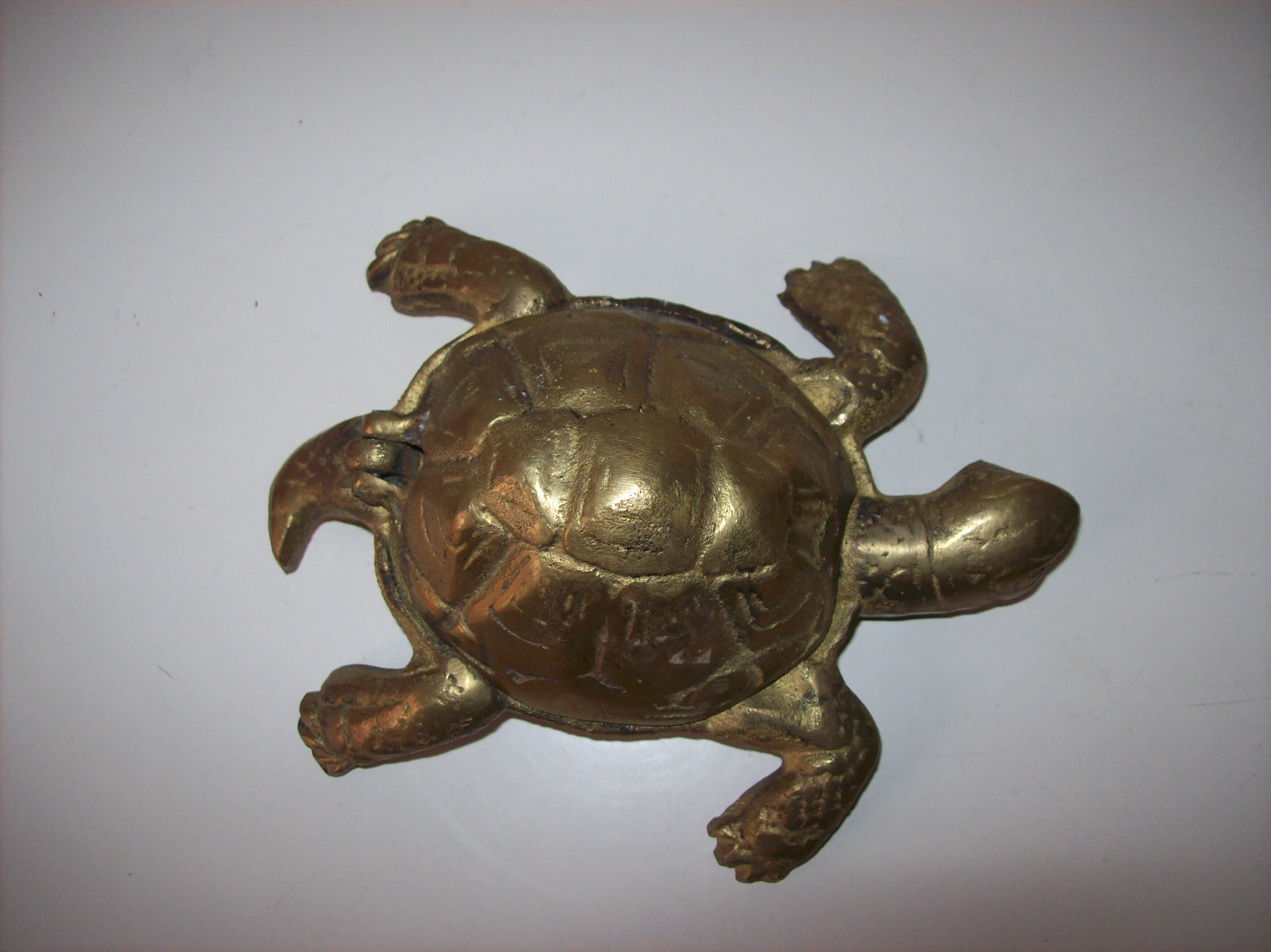 Golden brass ashtray has a turtle-shaped