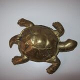 Golden brass ashtray has a turtle-shaped