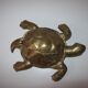 Golden brass ashtray has a turtle-shaped