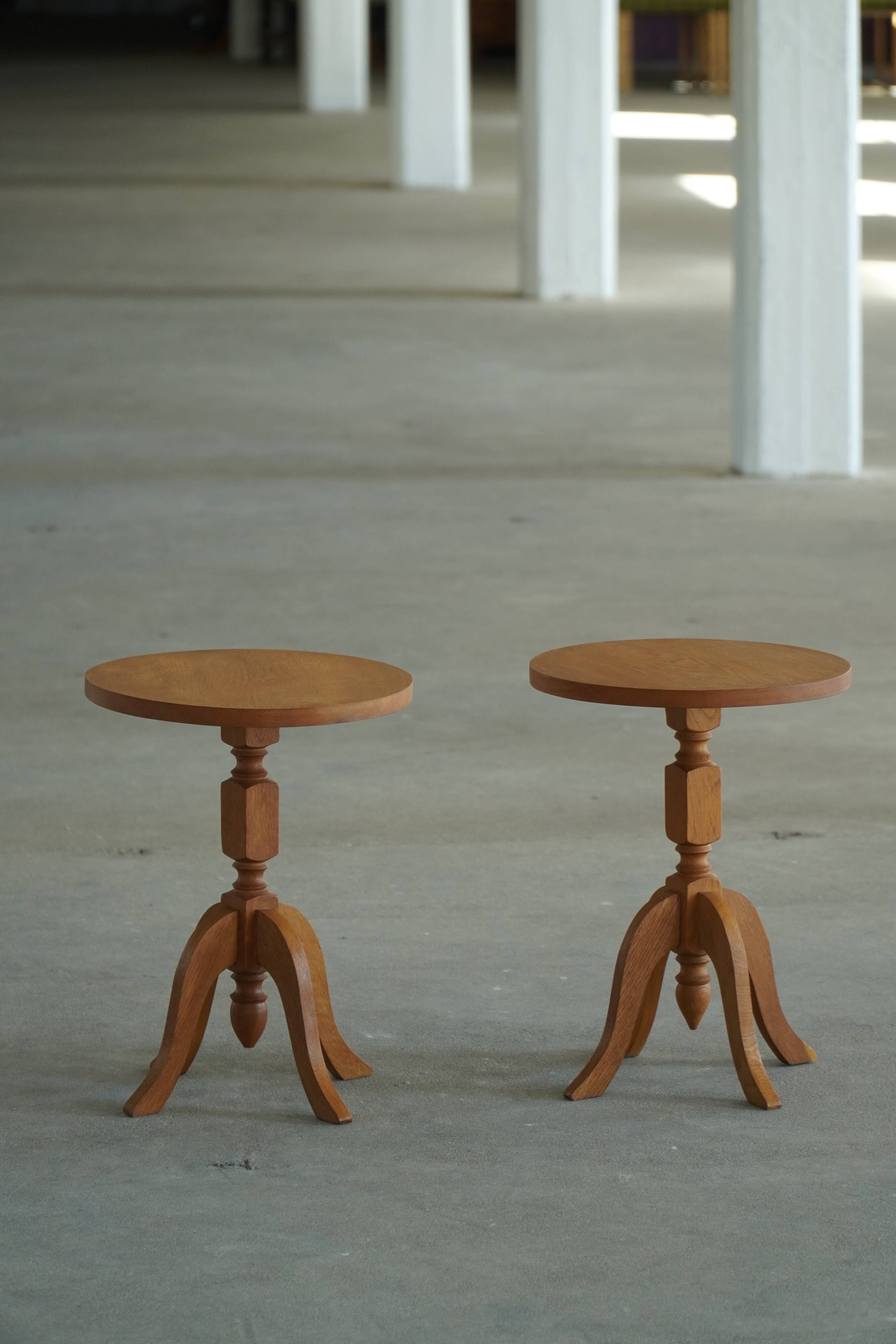 Pair of Scandinavian oak side tables with central legs and sculptural curved feet, 1960s.