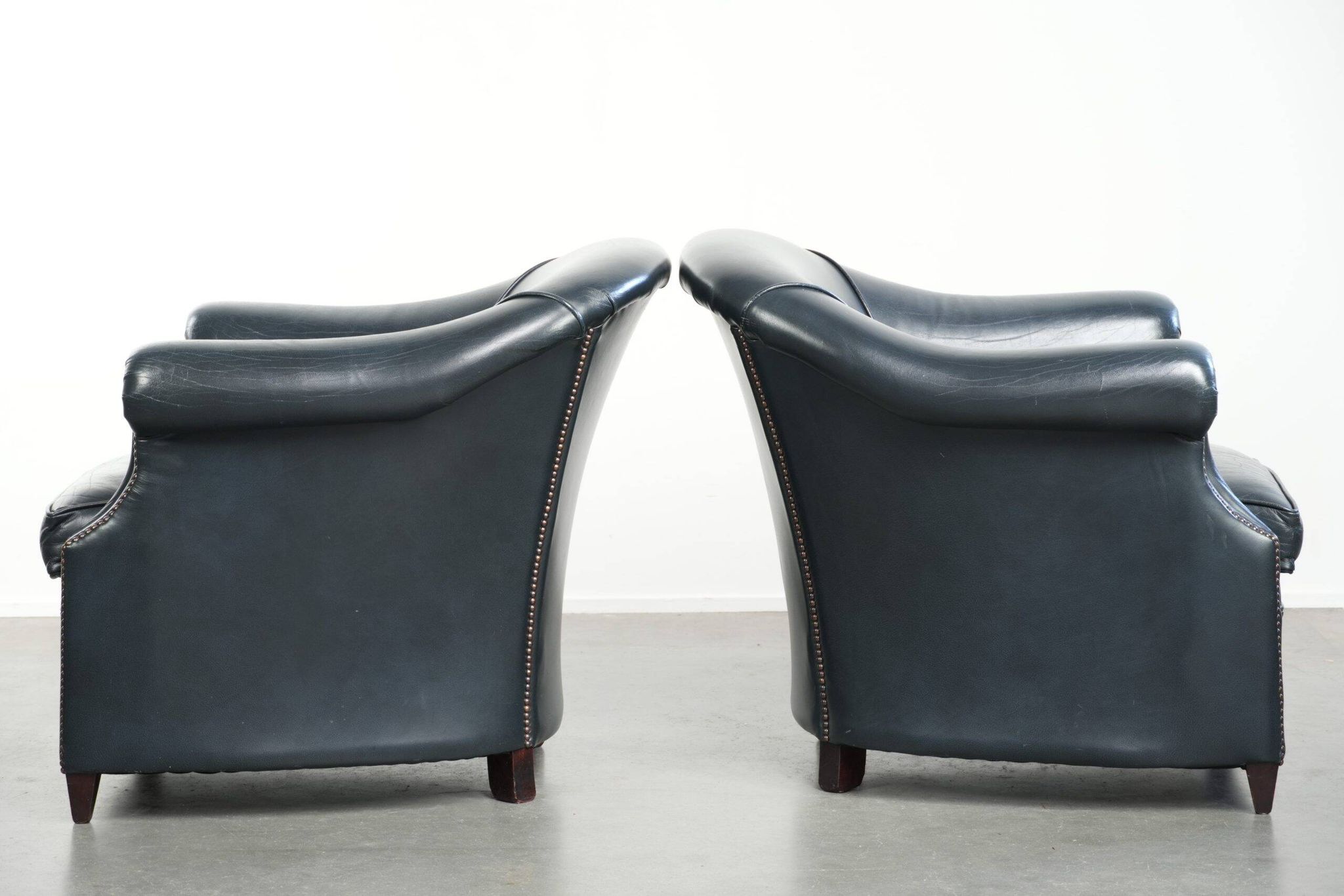 Set of dark blue cow leather club armchairs with a unique design