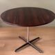 Round table in varnished rosewood