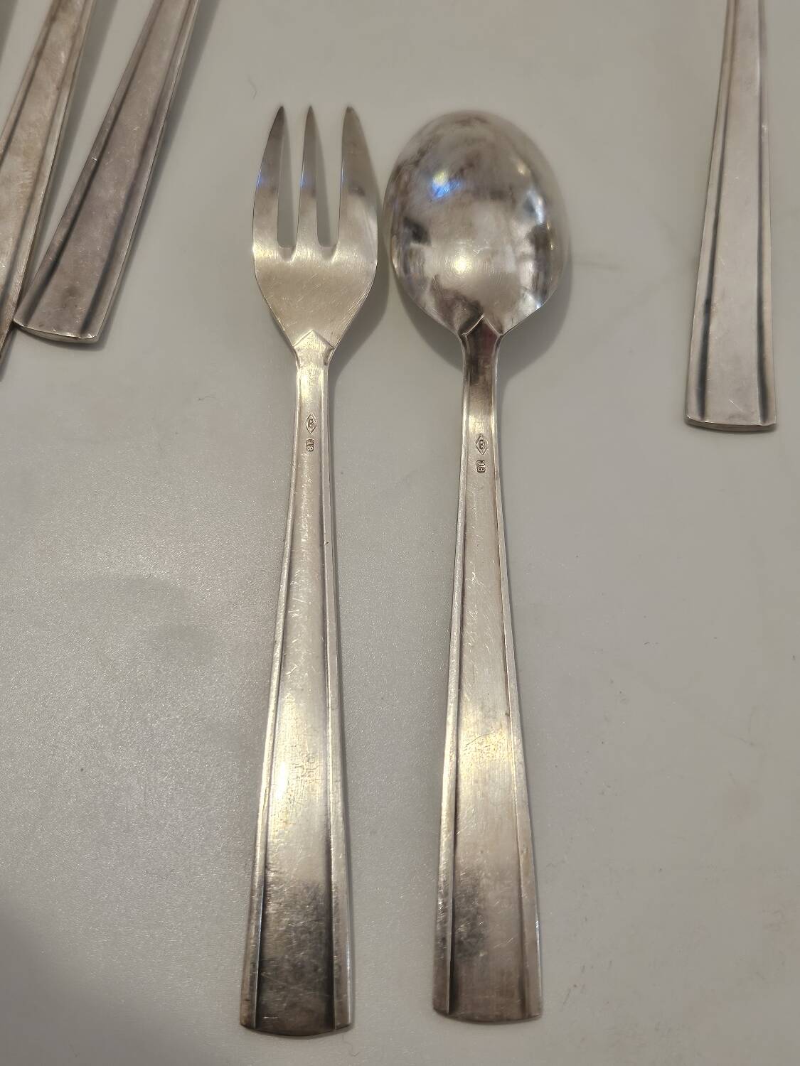 Set of silver dessert spoons and forks