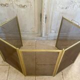 Five-panel golden metal fireplace screen from the 19th century.