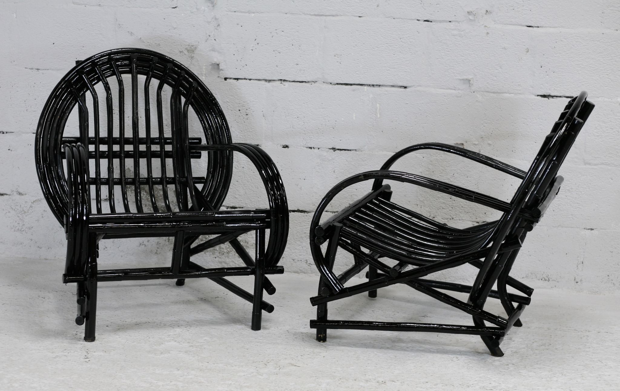 Pair of black lacquered rattan armchairs. France, cira 1960.
