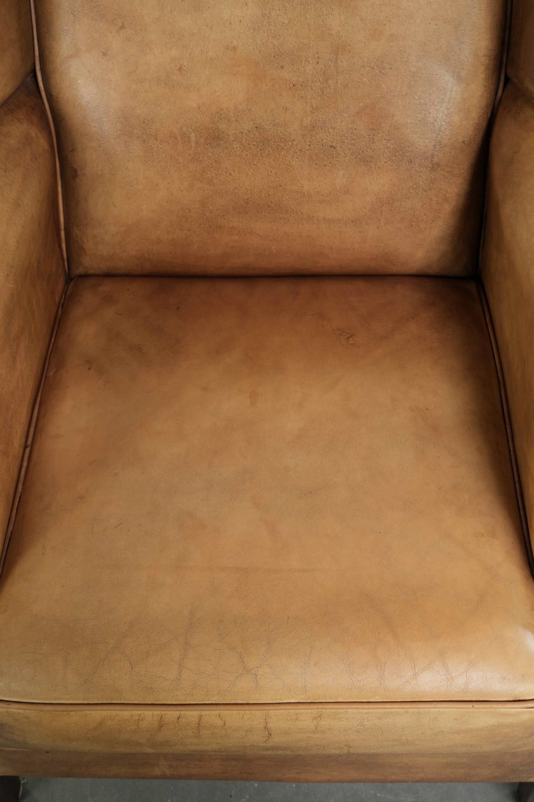 Comfortable cowhide wingback armchair with a timeless English look