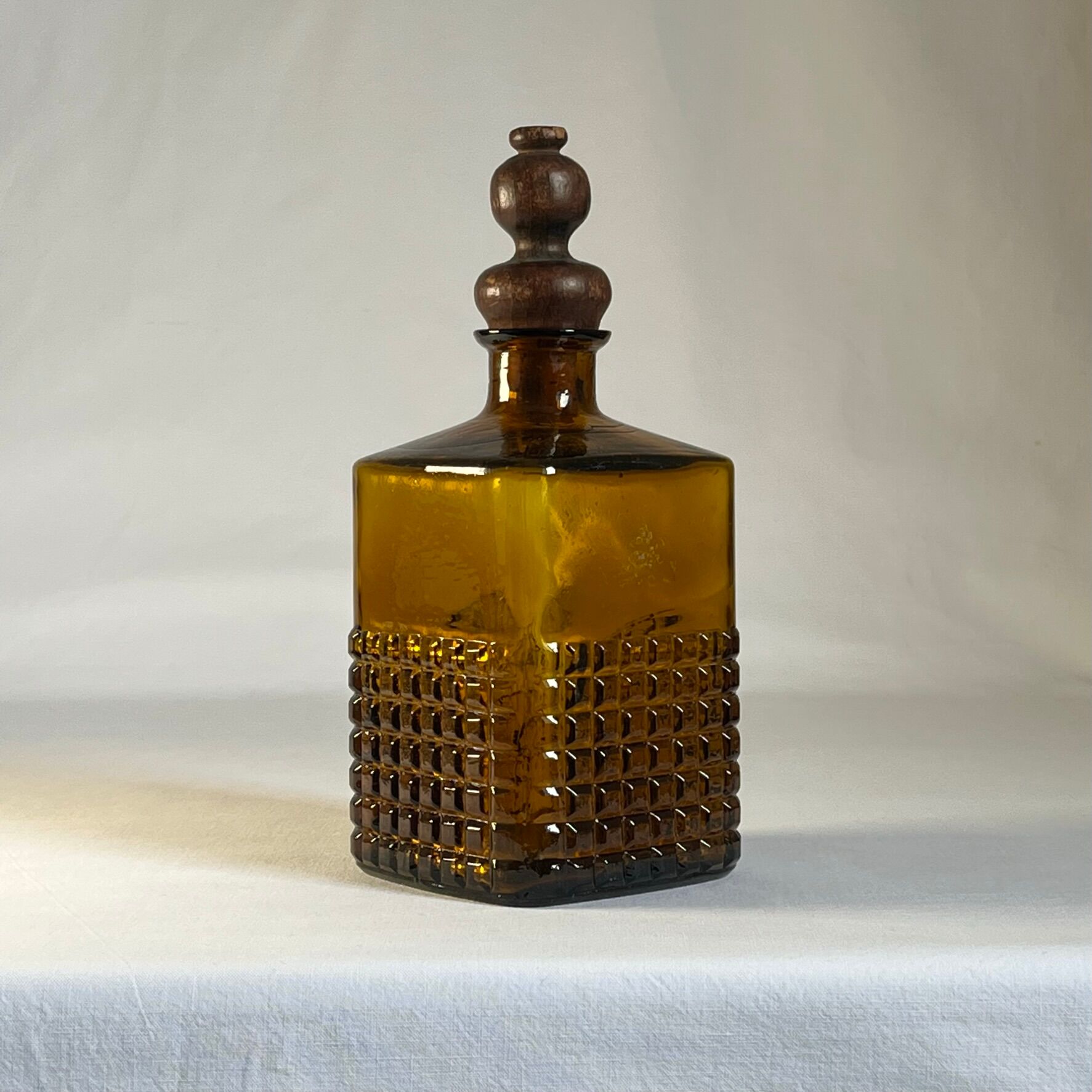 Amber glass and wood bottle