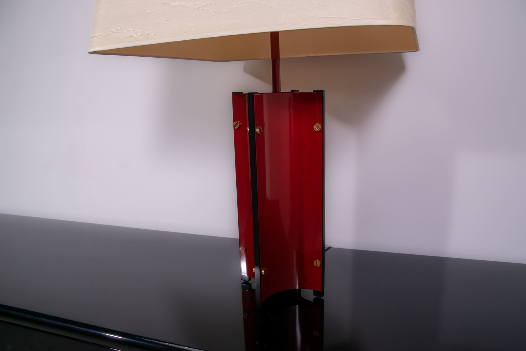 Red metal sculptural table lamp with oversized lamp shade circa 1980