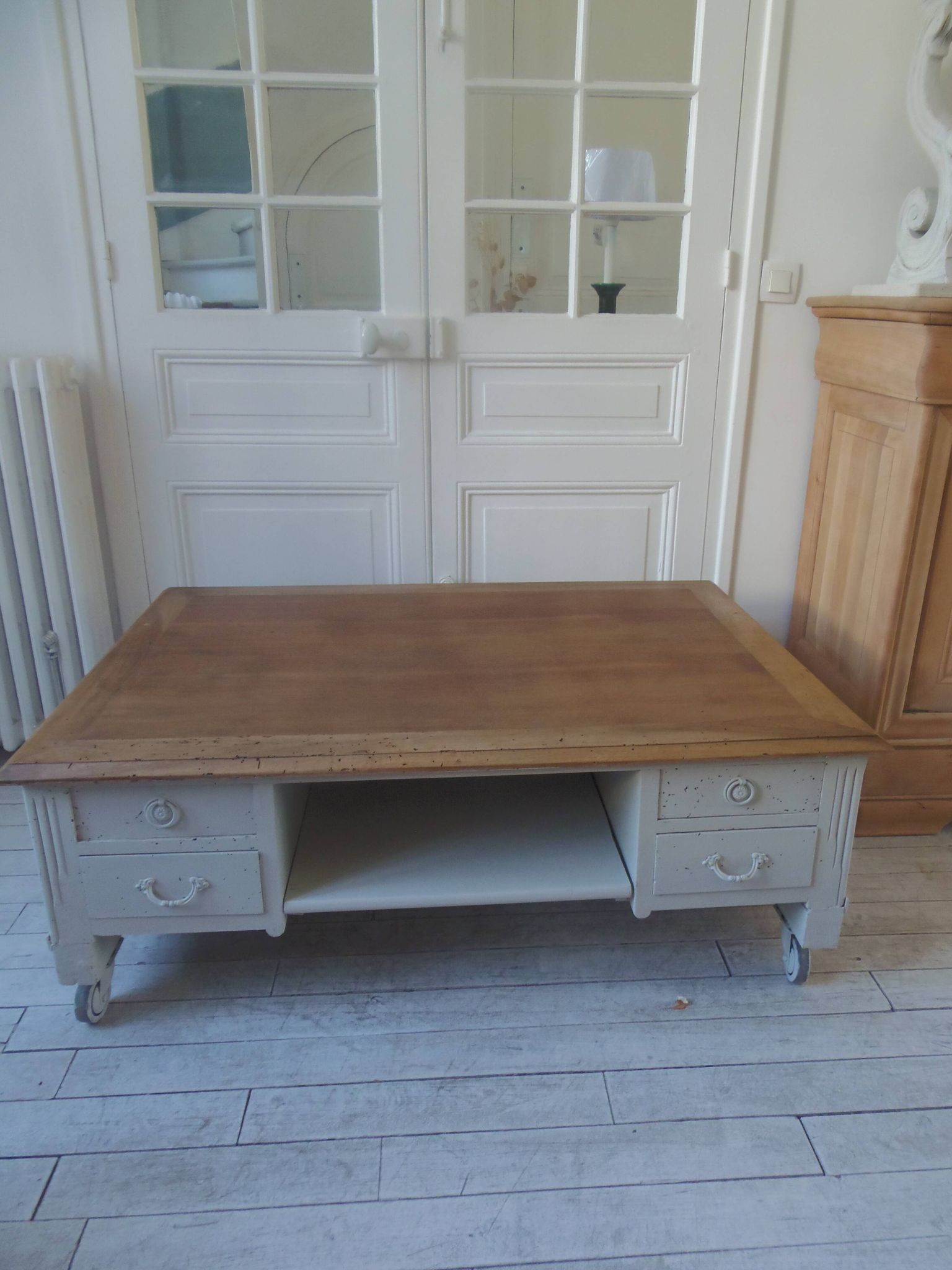 Coffee table on casters, made from an old desk, pearl gray base and belt.