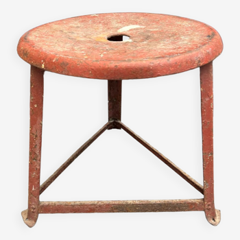 Red tripod industrial metal stool