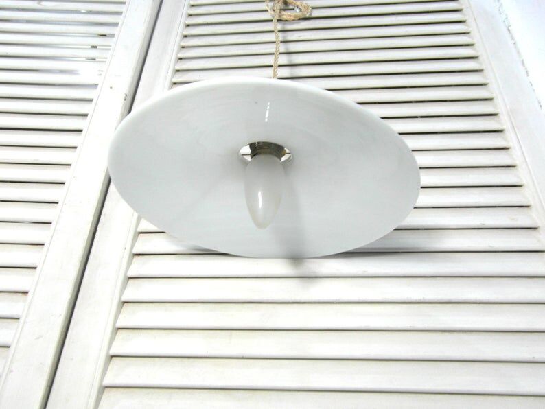 Hanging in opaque white glass.