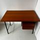 Vintage wooden and metal desk in modernist style.