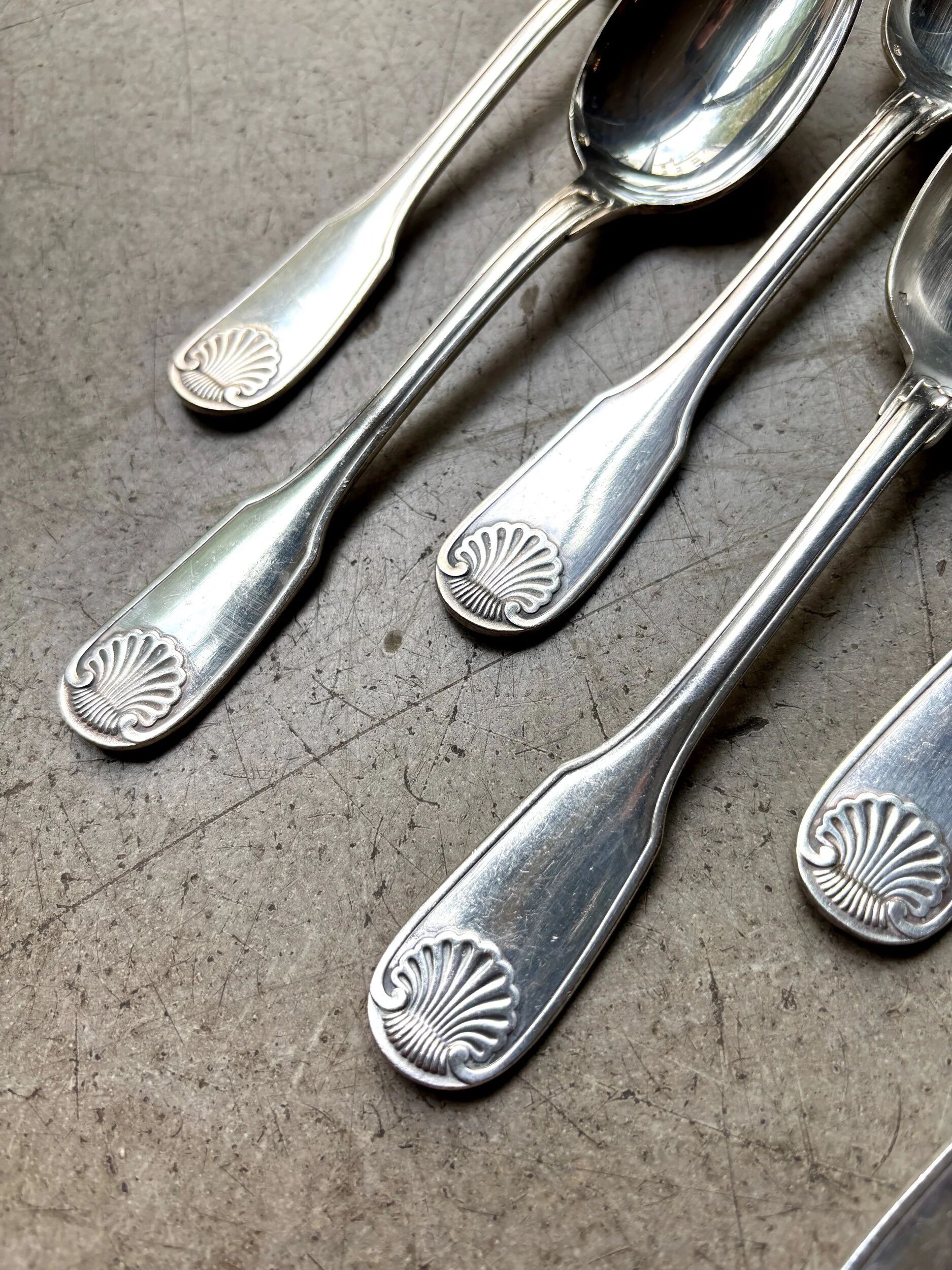 6 large Christofle silver-plated spoons with shell decoration.